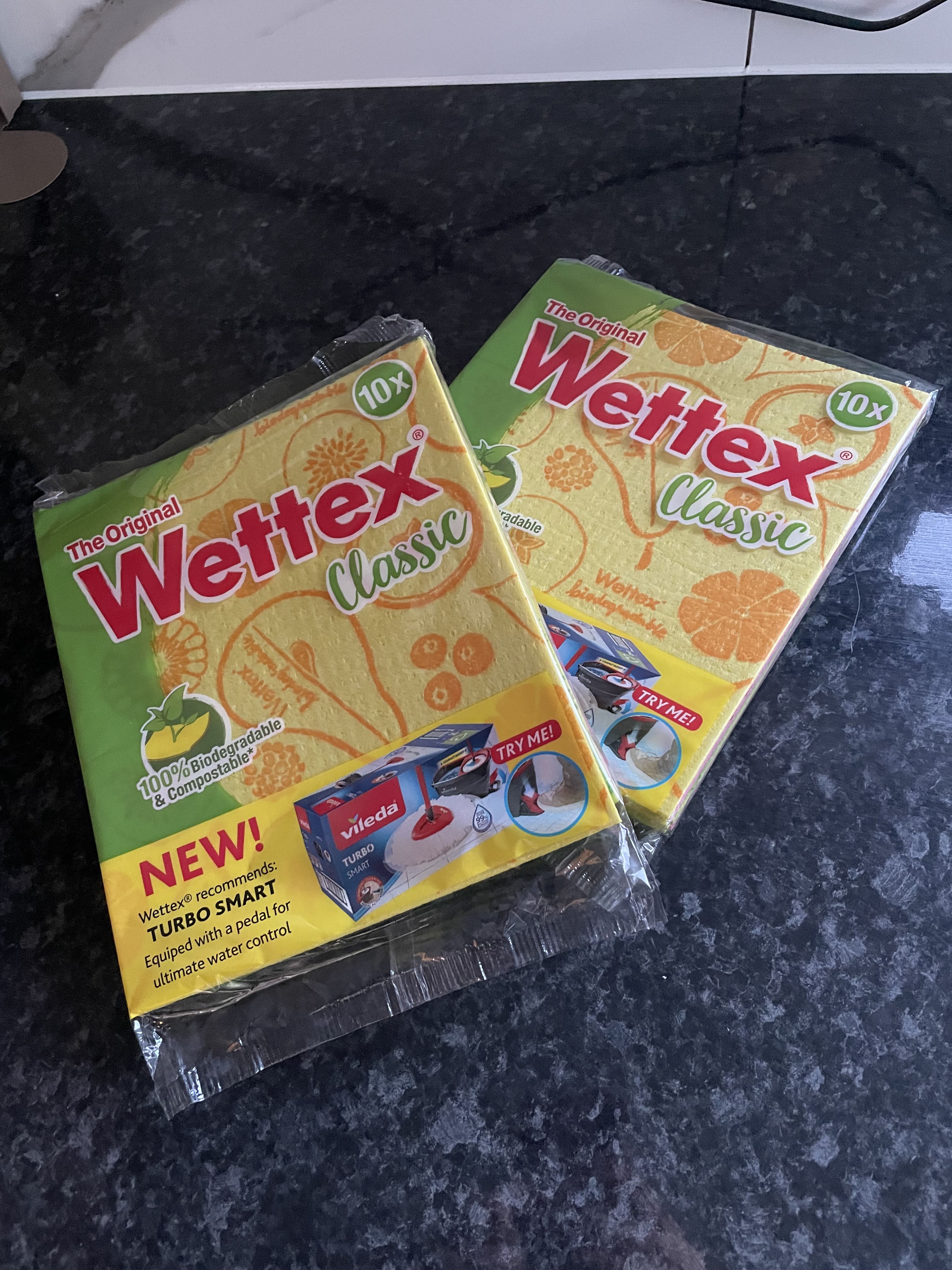 Two multipacks of Wettex Original Classic Dishcloths from Sweden on a countertop.